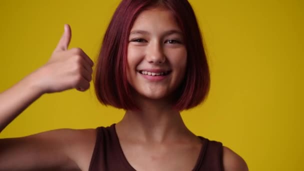 Video One Girl Showing Thumbs Yellow Background Concept Emotions — Stockvideo