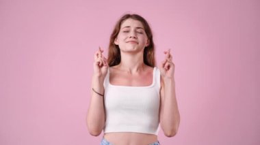 4k video of girl begging please on pink background. Concept of emotions.