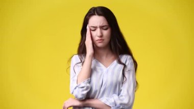 4k video of one girl feeling bad over yellow background. Concept of emotions.