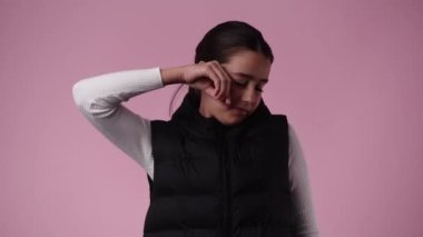 4k video of one girl yawning over pink background. Concept of emotions.
