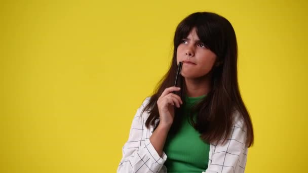 Video Una Chica Pensando Algo Sobre Fondo Amarillo Concepto Emociones — Vídeos de Stock