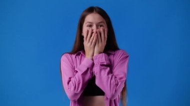 4k video of woman touching body and face isolated on blue background. Concept of emotion.