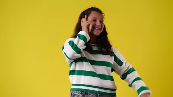 Video Von Einem Mädchen Das Auf Gelbem Hintergrund Telefoniert Konzept — Stockvideo