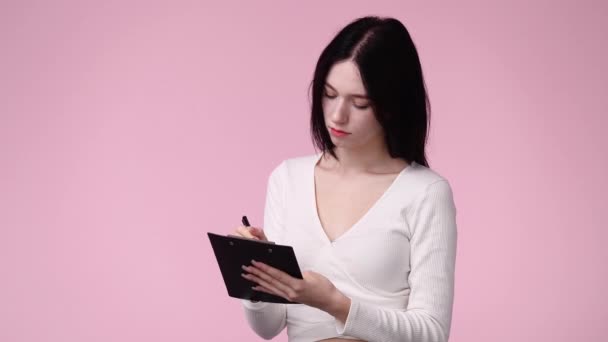 Video One Girl Taking Some Notes Pink Background Concept Emotions — Stockvideo
