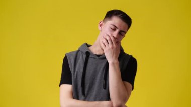 4k video of a man thinking about something over yellow background. Concept of emotions.