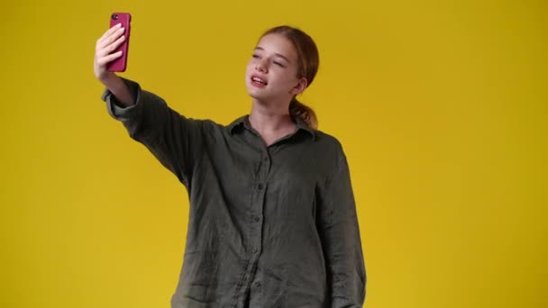 Video Girl Using Her Phone Yellow Background Concept Emotion — ストック動画