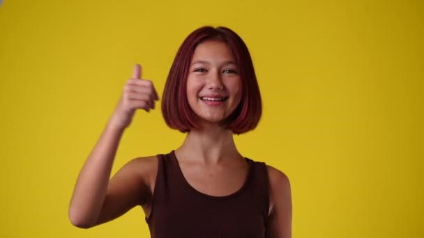Video One Girl Pointing Camera Showing Thumbs Yellow Background Concept — Stock Video