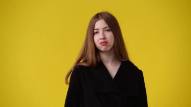 4k video of one girl feeling bad over yellow background. Concept of emotions.