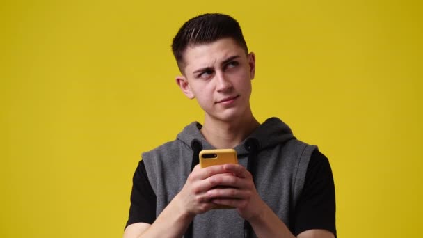 Video One Man Using Phone Yellow Background Concept Emotion — Vídeos de Stock