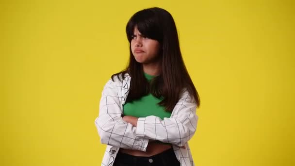 Video One Girl Crosses His Arms Thinking Something Yellow Background — Wideo stockowe