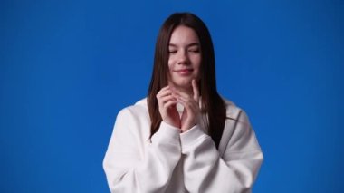 4k video of cute woman over blue background. Concept of emotions.