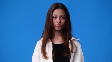 4k video of girls facial expression on yellow background. Concept of emotions.