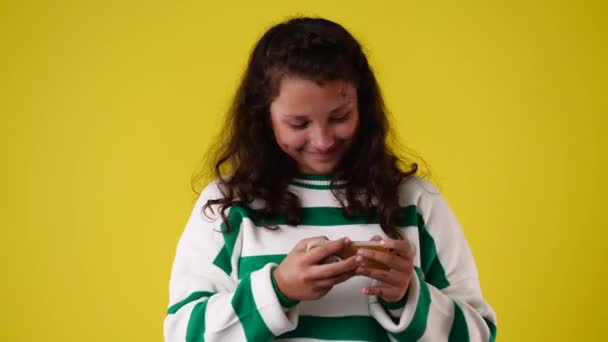 Video One Girl Playing Phone Yellow Background Concept Emotions — Stok Video