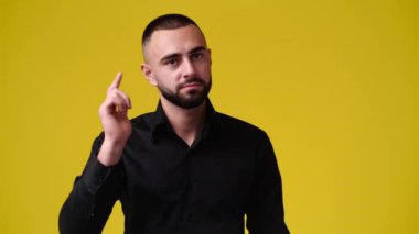 Sarı arkaplan üzerinden arayacağı birini gösteren 4K yavaş çekim videosu. Duyguların kavramı.