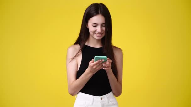 Video One Girl Sending Messages Yellow Background Concept Emotions — 图库视频影像