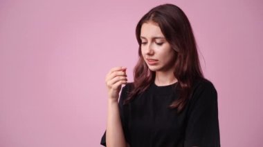 4k video of one girl posing for a video over pink background. Concept of emotions.