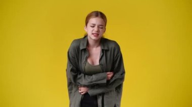 4k video of one girl feeling bad over yellow background. Concept of emotions.