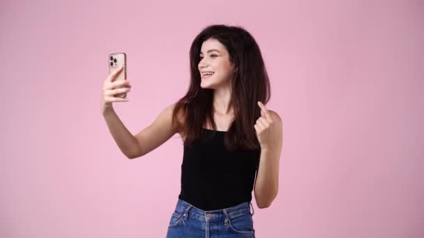 Video Cute Girl Using Phone Waving Hello Pink Background Concept — Stock video