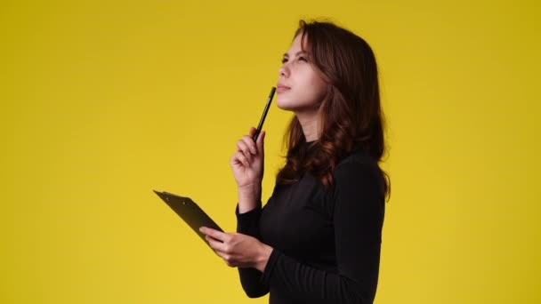 Video One Girl Taking Some Notes Yellow Background Concept Emotions — Vídeos de Stock