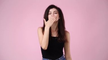 4k video of one girl posing for a video over pink background. Concept of emotions.