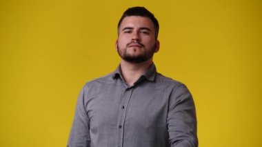 4k video of one man posing for a video over yellow background. Concept of emotions.