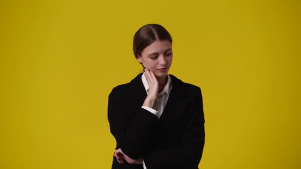 黄色の背景に狡猾な顔の表情を持つ少女の4Kビデオ アイデアを持つ少女の概念 — ストック動画