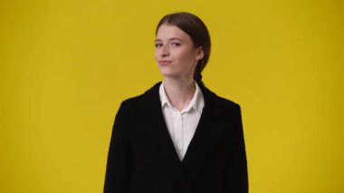 Sarı sırt çantasından gülümseyen bir kızın 4K videosu. Duyguların kavramı.