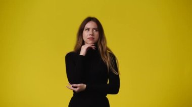 4k video of one girl showing thumbs up over yellow background. Concept of emotions.