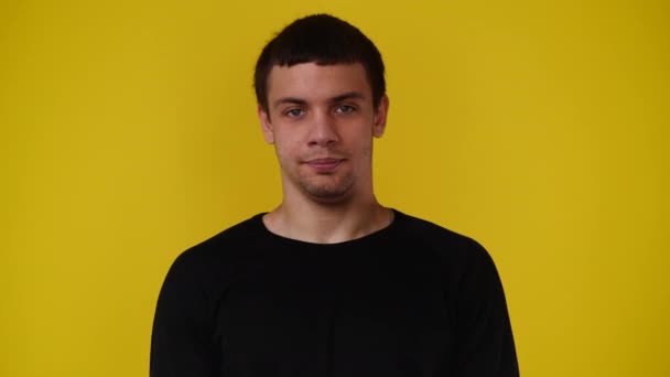 黄色の背景に頭をぶつけることに同意する1人の男の4Kビデオ 感情の概念 — ストック動画