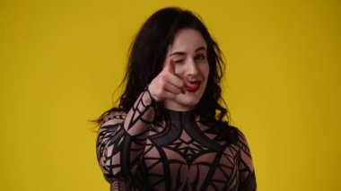 4k slow motion video of one woman asks to call someone over yellow background. Concept of emotions.
