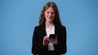 4k video of one girl sending messages on blue background. Concept of emotions.