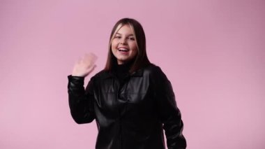 4k video of one girl posing for a video over pink background. Concept of emotions.