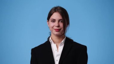 4k slow motion video of one woman with positive emotions over blue background. Concept of emotions.