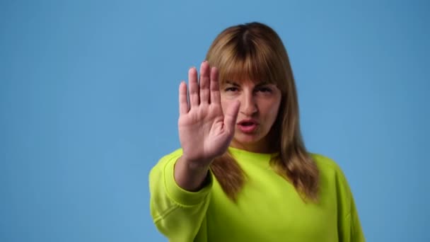 Відео Однієї Дівчини Показує Знак Зупинки Синьому Фоні Поняття Емоцій — стокове відео
