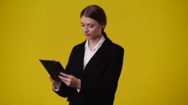 4k video of one girl showing thumbs up over yellow background. Concept of emotions.