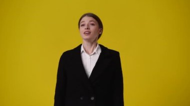 4k video of girl begging for something on yellow background. Concept of emotions.
