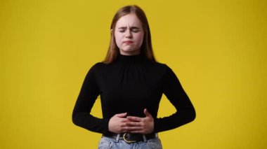 4k video of one girl feeling bad over yellow background. Concept of emotions.