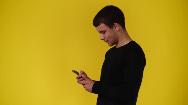 Video One Man Using Phone Yellow Background Concept Emotion — Video Stock