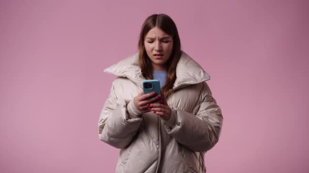Video One Girl Using Her Phone Pink Background Concept Emotions — 图库视频影像