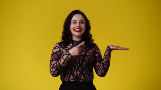 Video One Girl Pointing Right Yellow Background Concept Emotions — 图库视频影像