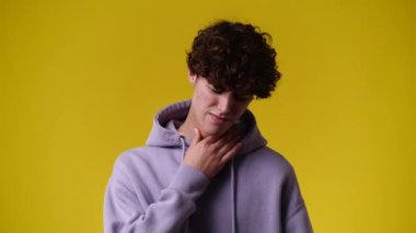 4k video of one man posing for a video over yellow background. Concept of emotions.