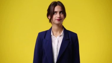 4k video of one girl posing for a video on yellow background. Concept of emotions.