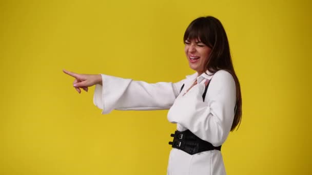Video One Girl Pointing Left Yellow Background Concept Girl Ideas — Stock Video