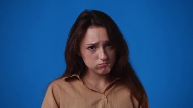 4k video of girls facial expression on yellow background. Concept of emotions.