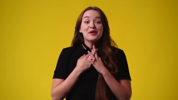 黄色い背景の上で笑っている可愛い女の子の4K動画 感情の概念 — ストック動画