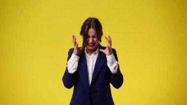 4k video of one girl feeling bad over yellow background. Concept of emotions.