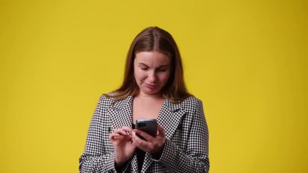 Video Una Mujer Que Escribe Texto Teléfono Sobre Fondo Amarillo — Vídeo de stock