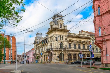 Szeged, Hungary. Front view the facade of beautiful old building with old sculptures in the city center