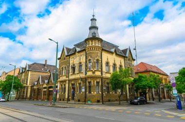 Szeged, Hungary. Front view the facade of beautiful old building with old sculptures in the city center