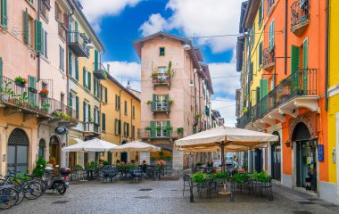 Brescia, Italy. Traditional colorful building with balconies, shutter windows and multicolored walls in typical italian street clipart